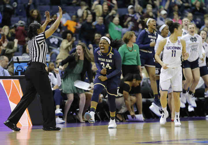 Notre Dame guard Arike Ogunbowale (24) celebrates hitting a shot to take the lead near the end of the fourth quarter of the NCAA Final Four game against the Connecticut Huskies at Nationwide Arena in Columbus.    (Adam Cairns / The Columbus Dispatch)
